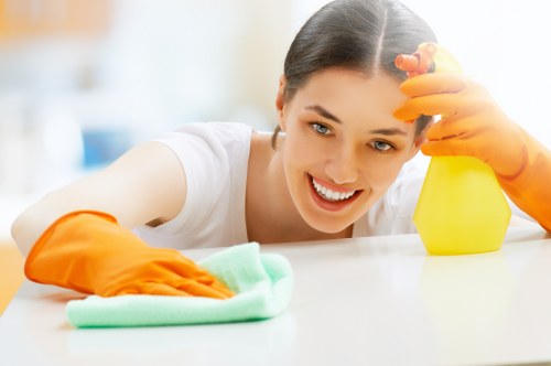 Technician applying cleaning product carefully during a carpet cleaning task